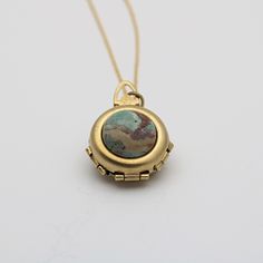 "*Our current stock of green opal is a dark mossy green* A spring-loaded locket pops open to reveal 2 hinged panels, just 1\" in diameter.  It opens to hold 4 photographs. The feature of this unique locket is a green opal.  This is considered a cleansing and rejuvenating stone. These are natural stones and each one will be different.  ~Comes on a 24\" chain" Family Heirloom Jewelry, Unique Jewelry Vintage, Mossy Green, Jewelry Lockets, Heirlooms Jewelry, Family Jewels