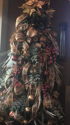 a christmas tree decorated with ribbons and ornaments