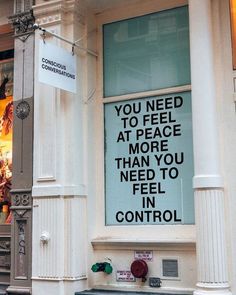 a sign on the side of a building that says you need to feed at peace more than you need to feel in control