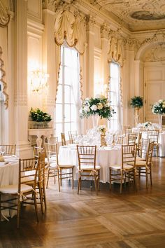 a dining room with tables and chairs set up for a formal function in the center