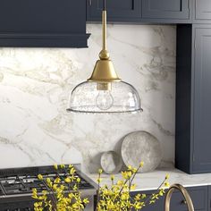 a kitchen with marble counter tops and blue cabinets, yellow flowers in vases on the stove