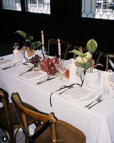 a table set with place settings and candles