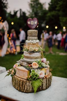 a wedding cake made out of logs and flowers