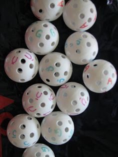 white bowling balls with numbers on them are scattered around the image, which appears to have been made out of plastic