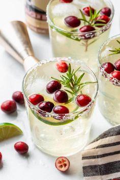 two glasses filled with cranberry gin cocktails and garnished with rosemary