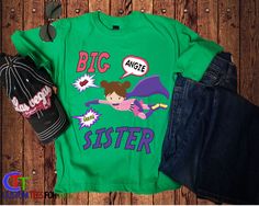 Introducing our Personalized Big Sister Superhero Shirt, the perfect way to announce the arrival of a new baby sister and celebrate the little superhero in your family! Customized with your child's name, this tee is a unique and fun way for your big sister to show off her special role. This shirt is also a great way to get your child excited about becoming a big sister. It can be used as a cute and creative way to announce the news to family and friends, or as a special gift for your child to wear on the first meeting with their new sibling. Make your child feel like a real superhero with our Custom Girls Superhero Big Sis Shirt. Order now and let your little one proudly display their new title and show off their superhero side! --> OUR SHIRTS <-- - Our Shirts are Made to order - Our shirt Becoming A Big Sister, Big Sister Announcement Shirt, Sister Announcement, Big Sister Announcement, New Sibling, Superhero Shirt, Sibling Shirts, First Meeting, Big Sister Shirt