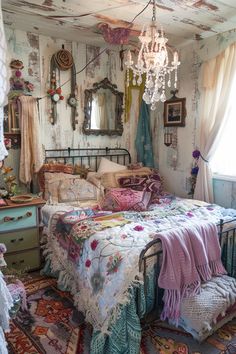 a bed room with a neatly made bed and a chandelier hanging from the ceiling