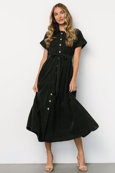 Baltic Born exclusive style Washed black color Cotton-poly blend material has no stretch Collared Functional buttons down front of dress Cuffed short sleeves Removable self-tie waist sash Tiered maxi length Unlined 90% Cotton, 10% Polyester Casey is 5'8, cup size 32B, size 2 and wearing size S Button Up Maxi Dress, Semi Casual, Baltic Born, Waist Sash, Cuffed Shorts, Button Up Dress, Tiered Maxi Dress, 80 Dress, Tier Skirt