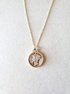 *Mercury Coin Pendant Necklace* -This necklace has a real vintage United States Mercury dime set in Solid 14K Gold with a 14k gold-fill chain -Bezel setting is open on the front and back so the coin can be own either way. -Pendant measures 7/8 inch. -Available in a 16in or 18in chain 14k Gold Coin Jewelry Stamped 14k, Timeless 14k Gold Coin Pendant Necklace, Nickel-free Yellow Gold Medallion Coin Necklace, Antique Gold Coin Pendant Jewelry For Collectibles, Vintage Gold Sterling Silver Necklaces, Antique Gold Jewelry With Coin Pendant For Collectors, Collectible Coin-shaped Elegant Necklace, Nickel-free Antique Gold Round Jewelry, Antique Gold Nickel-free Jewelry