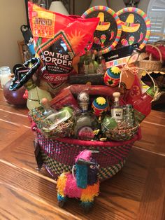 a basket filled with assorted items sitting on top of a wooden table