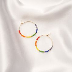 Show off your artsy side with our Seed Bead Classic Hoops. Fun and colorful, these hoops are available in two sizes and five color combination options. Choose the calming colors of the ocean, the neutral tones of the desert, the bright colors of mosaic, the neutral colors of maple or the array of colors in the rainbow. The hoops are 14k gold filled and pair beautifully with our glass Seed Bead Necklace. Colors In The Rainbow, Glass Seed Bead Necklace, Calming Colors, Seed Bead Necklace, Neutral Tones, The Desert, Color Combination, The Rainbow, Bead Necklace