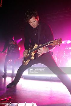 a man playing an electric guitar on stage