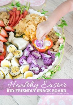 a kid's hand picking up some food from a basket with the words healthy easter kid - friendly snack board