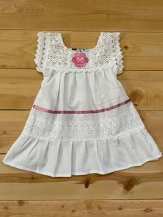 "Beautiful! Mexican baby girl dress hand embroidered! Beautiful details on this dress, it makes it one of a kind ! Fabric: cotton- manta. Care : hand washing/ hang to dry. MEASUREMENTS: Length: 18\" Armpit to armpit: 11\" READY TO SHIP !" White Cotton Dress With Machine Embroidery, White Cotton Embroidered Beach Dress, Cute Handmade Sleeveless Dress, Bohemian Cotton Embroidered Dress With Lace Trim, Bohemian Embroidered Cotton Dress With Lace Trim, Traditional Handmade Cotton Dresses, Cute White Dress With Embroidered Hem, White Cotton Embroidered Dress With Lace Trim, Embroidered Summer Dresses For Baptism