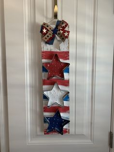 an american flag door hanger with stars on it and a bow in the middle