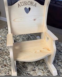 a wooden chair with the word aurora on it