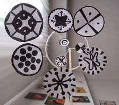 a white table topped with lots of black and white paper cut out circles on top of it