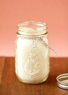 a mason jar filled with white liquid sitting on top of a wooden table