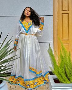 This dress is a beautiful, traditional Ethiopian Tilef design, combining elegance with intricate detailing, making it perfect for formal occasions or cultural celebrations. Material Cotton Menen Thread Estimated delivery : 1 week to 2weeks Contact WhatsApp +1(304)-306-2784Email: contact@ethiopian.store Traditional V-neck Festive Dress, Elegant Dresses With Traditional Patterns For Navratri, Traditional Floor-length Dresses With Embroidered Border, Traditional V-neck Maxi Dress For Festive Occasions, Ceremonial Long Sleeve Festive Dress, Navratri Dress With Embroidered Border, Blue Kaftan For Traditional Ceremonies, Traditional Long Dress Kaftan For Festive Occasions, Traditional Long Dress Kaftan For Festive