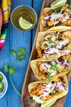 a plate topped with tacos and other foods