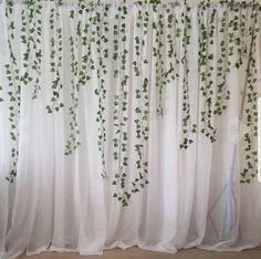 the curtains are covered with green ivy leaves