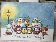 a christmas card with penguins, bears and reindeers in the snow under a street light