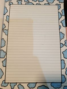 a piece of lined paper sitting on top of a table