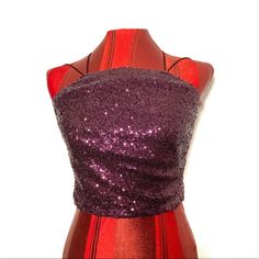 Make A Bold Statement With Theia Zoe Sequin Crop Top. This Stunning Purple Sleeveless Cutaway Spaghetti Crop Top Is The Epitome Of Glamour And Style. With Its Excellent Condition And Never Worn Status, It's Ready To Dazzle At Your Next Special Occasion. This Crop Top Is A Size 2, With A Pit-To-Pit Length Of 15 Inches And A Top-To-Bottom Height Of 12 Inches, Offering A Perfect Fit. Rest Assured, There Are No Rips, Stains, Or Tears On This Fabulous Piece. The Sequins Are All Intact, Ensuring A Shi Glamorous Cami Crop Top For Night Out, Halter Neck Party Tops With Straps, Party Halter Neck Top With Straps, Glamorous Fitted Cami Crop Top, Party Crop Top Tank With Straps, Purple Halter Neck Top For Party, Purple Sleeveless Crop Top For Night Out, Sleeveless Purple Crop Top For Night Out, Halter Neck Tank Top With Straps For Party