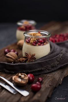 cranberries and nuts in a glass jar on a wooden board with spoons