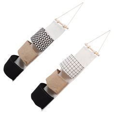 two pairs of socks hanging from strings with different patterns on them, one in black and white