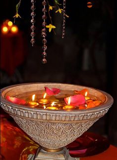 a decorative bowl with candles floating in it