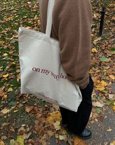 a person carrying a bag with the words on my way printed on it