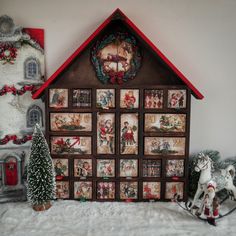 a christmas scene with a rocking horse next to a house and other holiday decorations on display