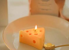 a piece of cheese sitting on top of a white plate