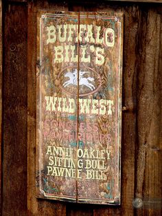 an old sign on the side of a wooden building that says buffalo bills wild west