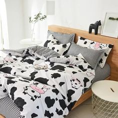 a bed with black and white cow print on the comforter, pillows and pillowcases