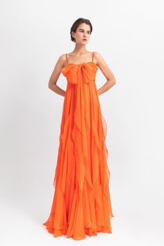 Long flared dress with a bow-like design and ruffled details. - HerTrove