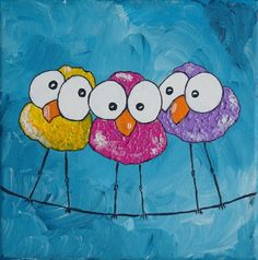 three little birds sitting on a wire with blue sky in the background and one is painted