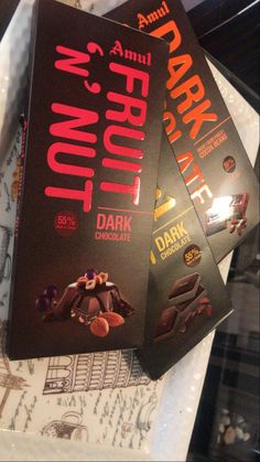 three dark chocolate bars sitting on top of each other