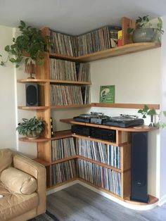 a living room filled with furniture and lots of bookshelves covered in vinyl records