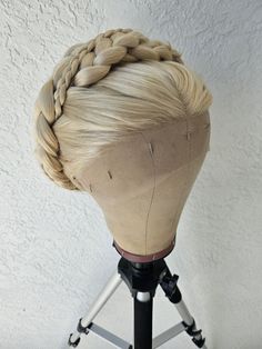 "This wig is inspired after young Princess Rhaenyra Targaryen during her coronation in House of the Dragon.  The wig starts off as a base 28\" lace front synthetic wig, which then has extra wefts hand sewn in to give more depth and fullness to the braids. It is then crimped, volumized, braided, and pinned to match her hair for her coronation. The hairline has been hand plucked to look more natural while worn. *Note - Due to the fact that this has extra wefts sewn it, it is slightly heavier than Rhaenerya Targaryen Hairstyles, Rhaenyra Targaryen Hairstyle, Rhaenyra Headpiece, Targaryen Braids, Rhaenyra Wig, 19th Century Hairstyles, 19th Century Hair, Fantasy Hair Wigs & Extensions, Princess Rhaenyra