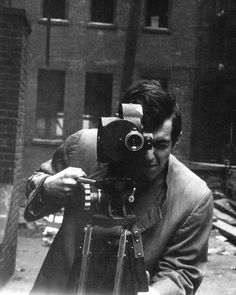 black and white photograph of a man holding a camera