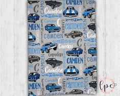 a blue and gray blanket with cars on it