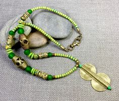 A beautiful green African necklace of 30 inches (plus pendant) in length, with Ghana Krobo Beads with a stunning brass pendant from Côte d'Ivoire. This is a wonderful one of a kind, head turning necklace which makes a perfect gift for that special someone for any occasion.  This piece of elegant African jewelry will accessorize many different fashions, and is appropriate for both day and evening wear. Yes, I can create custom necklaces! Just message me with your jewelry needs and let's see if I can make something special for you! COUPON CODES for savvy shopper's... Save 10% on purchases totaling $100 or more- enter coupon code 'SAVE10PERCENT' at checkout! Save 15% on purchases totaling $200 or more- enter coupon code 'SAVE15PERCENT' at checkout! Follow my original mixed media abstract coll African Beads Necklace, Krobo Beads, Custom Necklaces, Small Dangle Earrings, African Earrings, African Necklace, Turquoise Drop Earrings, Luxe Jewelry, Necklace For Her