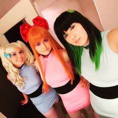 three women dressed up in costumes posing for the camera