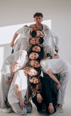 a group of people standing together in the middle of a circle with their arms around each other