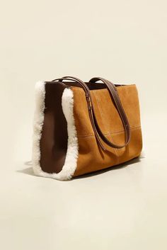 European Elegance Blends with Cozy Shearling Luxury As the autumn-winter season unveils, we're thrilled to introduce our spacious genuine leather shearling tote. Crafted with premium cowhide, its surface is meticulously refined to present a unique matte texture, providing users with a warm and upscale tactile experience. The design boasts a monochromatic theme, cleverly marrying European styling with a trendy squared bottom, achieving a look that's both minimalistic and modish. Its interior offe European Elegance, Matte Texture, Leather Care, Winter Season, Chocolate Brown, Leather Tote, Calf Skin, Leather Bag, Autumn Winter