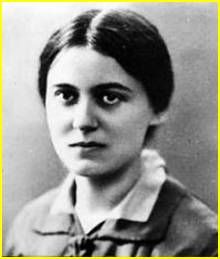 a black and white photo of a woman with short hair wearing a shirt and tie