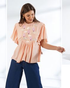 ▶ ABOUT THE TOP: This peach top is a statement of style. Hand embroidered with sequin and beads in shape of cute hot air balloons. Perfect for a day out at the office or a casual brunch with your friends. Made from georgette fabric, the top has a loose fit and we offer it in plus sizes up to 5XL. ▶ ITEM DETAILS: * Top made with georgette, medium weight, airy * The model is 5'7 tall and wearing size M. * Handmade item, crafted to perfection. * The length of the top is 19 inches ▶ FABRIC: * Made f Orange Embroidered Tops For Summer, Orange Short Sleeve Tops With Floral Embroidery, Orange Floral Embroidery Short Sleeve Tops, Orange Floral Embroidered Short Sleeve Tops, Embroidered Short Sleeve Party Tops, Pink Blouse With Embroidered Neckline For Spring, Feminine Pink Embroidered Summer Top, Feminine Pink Embroidered Top For Summer, Summer Fitted Top With Pearl Embroidery