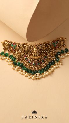 Immerse yourself in the enchanting beauty of the Sreeja Antique Nakshi Choker Set. Meticulously crafted with intricate Nakshi work, this set radiates timeless allure and elegance. Antique Choker, Choker Sets, Necklace Collection, Goddess Lakshmi, Choker Set, Antique Necklace, Jewelry Online, Pearl Drop, Indian Jewelry